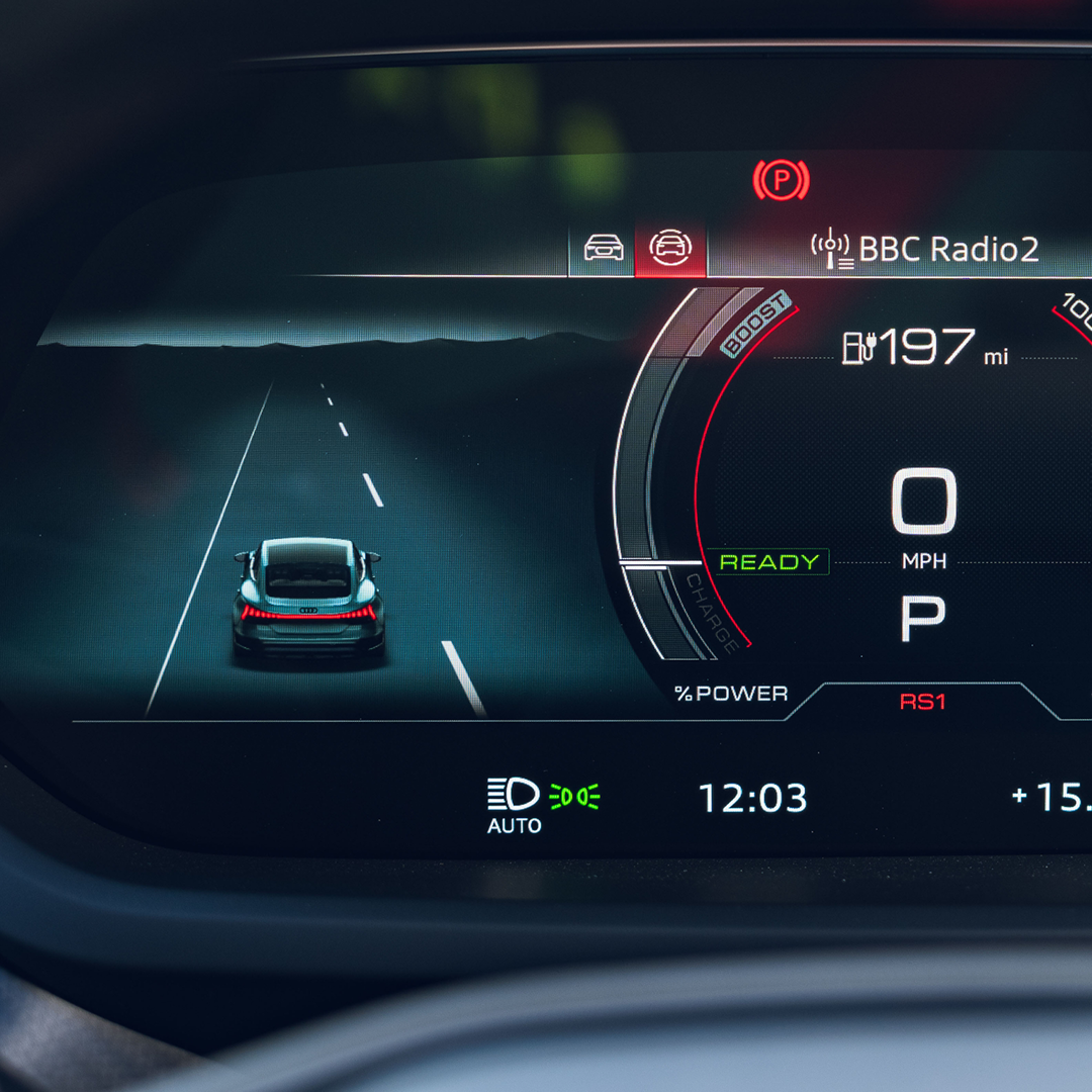 Car dashboard screen showing a road with a car, speedometer.