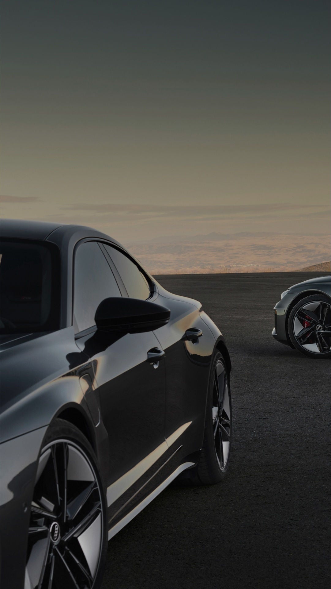 Two Audi electric vehicles parked side to side facing away from each other