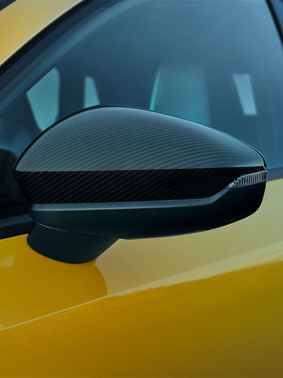 Detailaufnahme eines Außenspiegels mit Carbongehäuse an einem gelben Audi A3 allstreet.