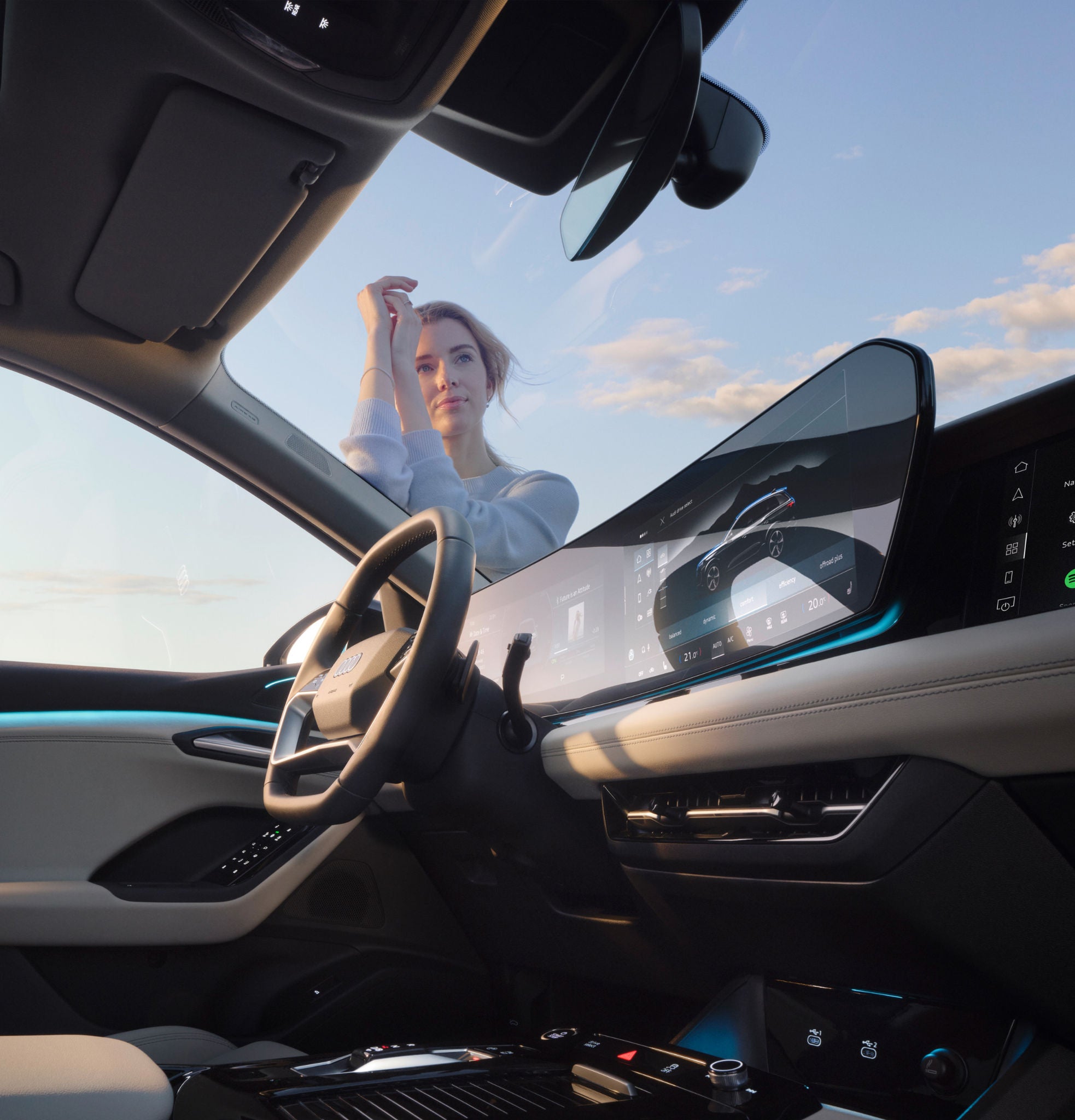 En person står och lutar sig mot huven på Q6 e-tron.