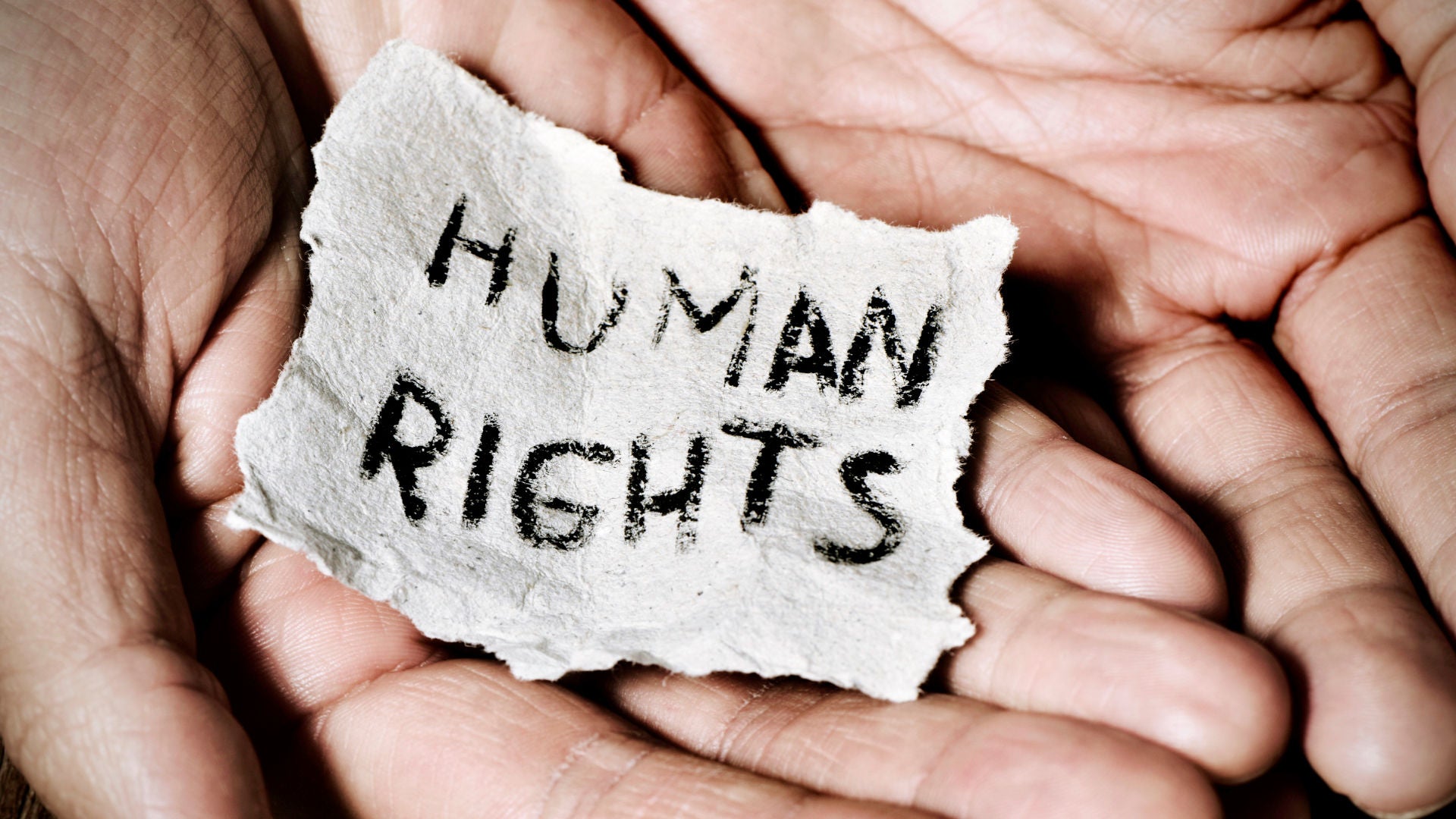 Hands holding a piece of paper with the inscription Human rights