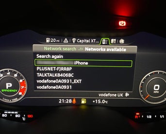 An Audi dashboard screen displaying Wi-Fi settings with a blurred out network name selected