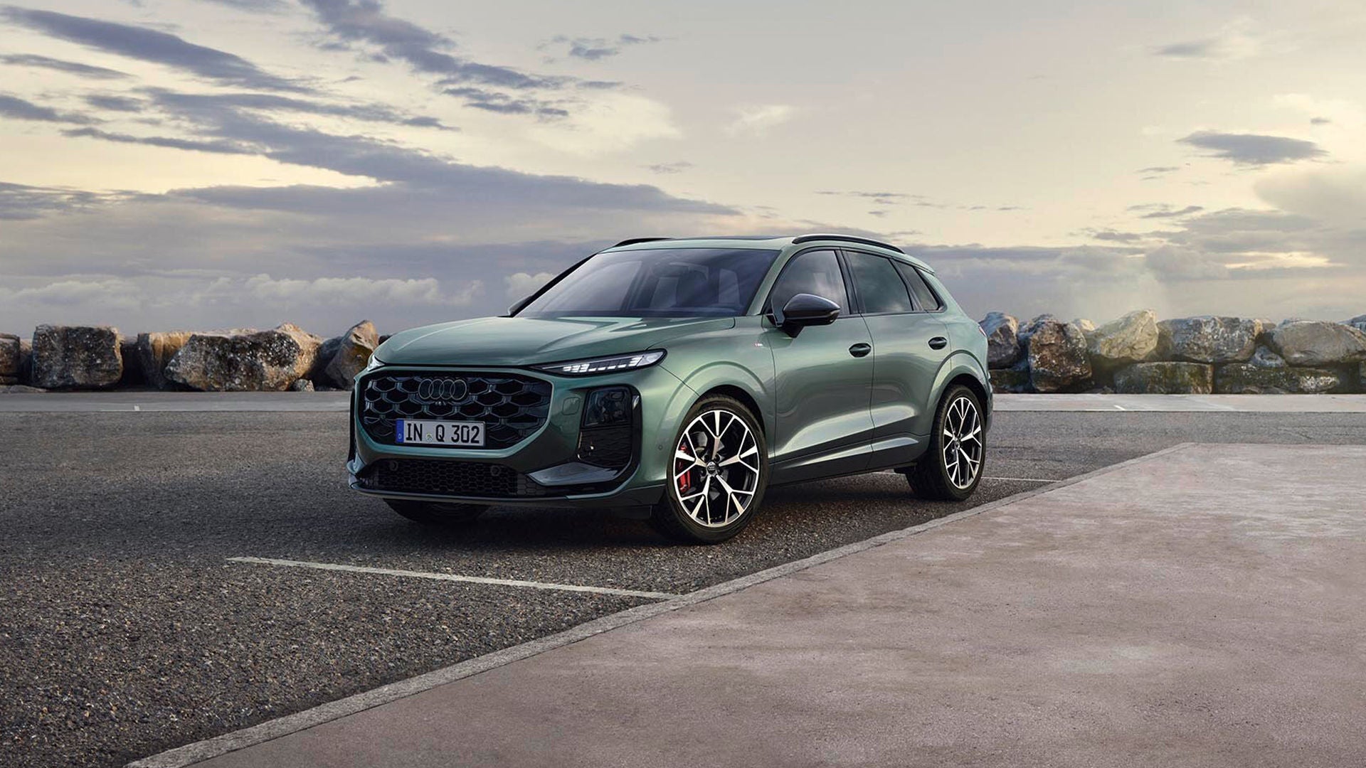 A parked Audi Q3 beside the shore