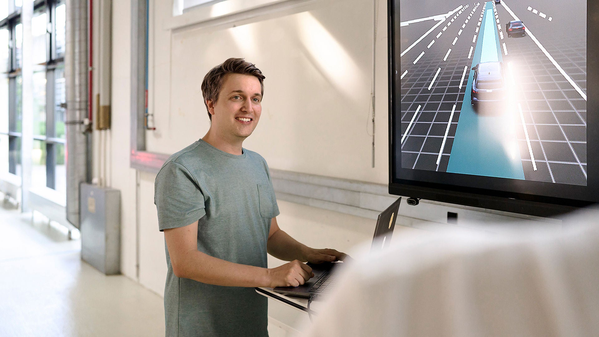 Jan Totz has a laptop in front of him and looks past the camera