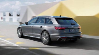 Silver Audi vehicle in motion with an abstract background