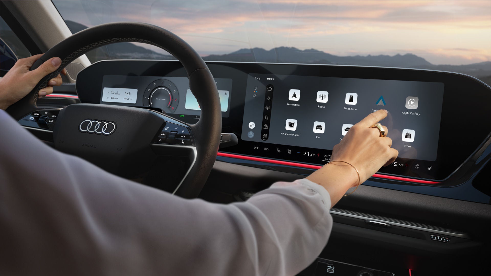 Close-up of the interior cockpit of an Audi: the steering wheel on the left, an illuminated display with app icons in the centre. A woman's arm extends into the picture from the left and taps on the display.