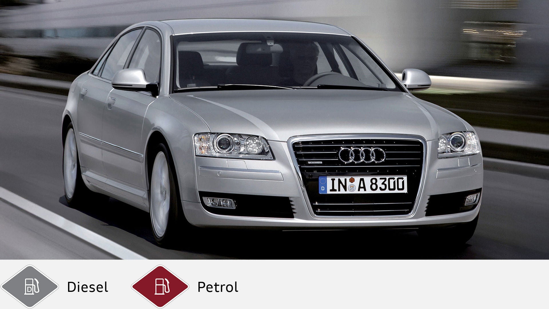 Silver Audi A8 driving on a road, driver clearly visible, urban background blurred. Below gray diesel symbol and red gasoline symbol.