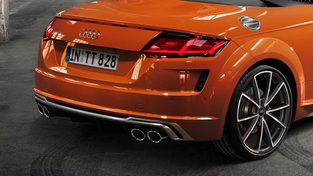 Rear view of back section of an orange Audi TT.