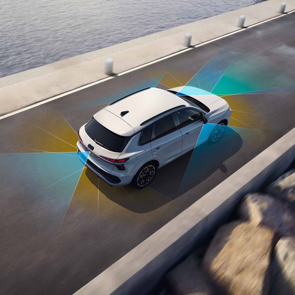 The Q3 SUV e-hybrid on a public road. The image shows the adaptive driving assistant's detection of lane boundaries marked in blue and yellow.