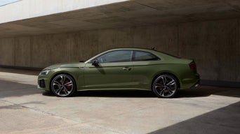 Green Audi A5 Saloon parked on shady patio