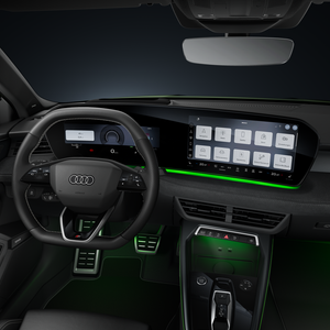 A view of the cockpit, focusing on the sports leather steering wheel and the curved panoramic display.