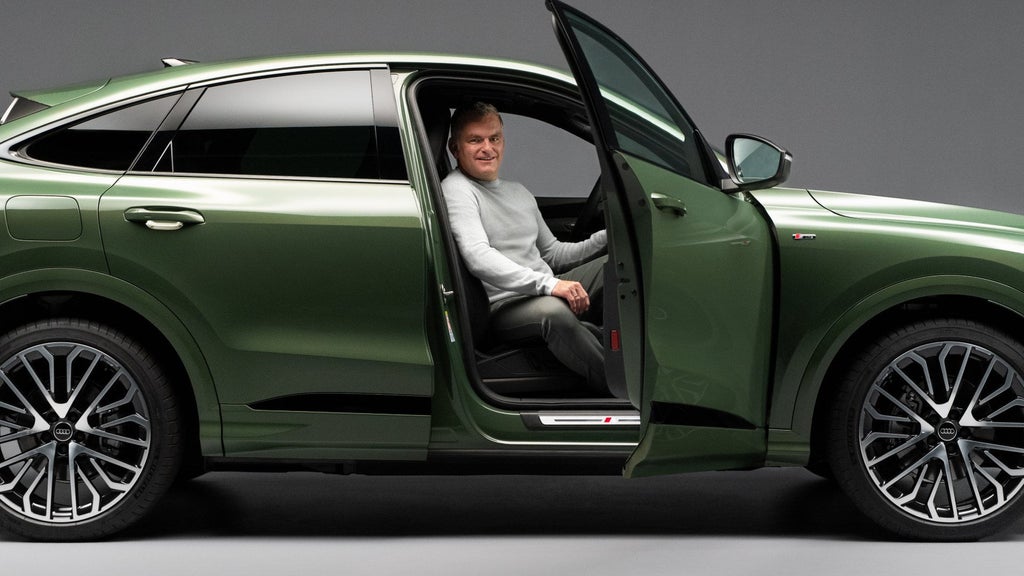 Display developer Roland Sager in the passenger seat of the Audi Q5 Sportback.