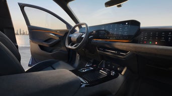 Interior of an Audi car with focus on the driver seat dashboard and steering wheel
