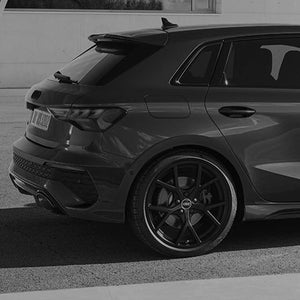 A grey image of the back half of an Audi RS 3