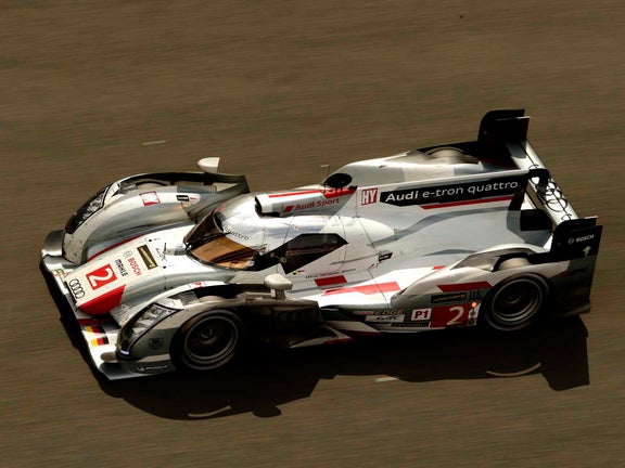 A picture showing the victorious Audi R18 e-tron quattro on track at Le Mans in 2013.
