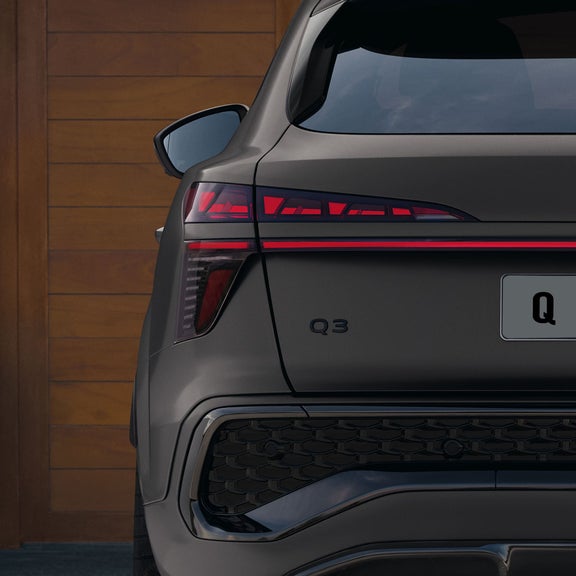 The Audi Q3 Sportback can be seen. It is a close-up of the rear, focusing on the OLED technology used in the rear lights.