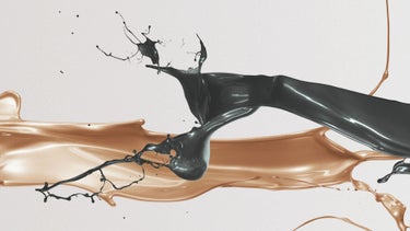 Dynamic swirls of black and bronze liquid on a light background.