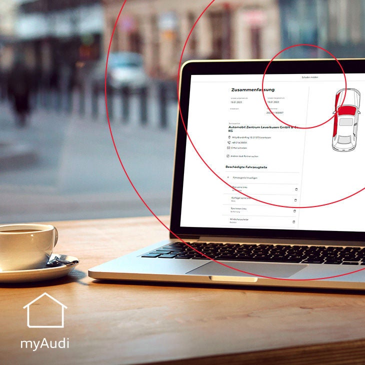 Ein geöffneter Laptop zeigt eine Fahrzeugübersicht in myAudi