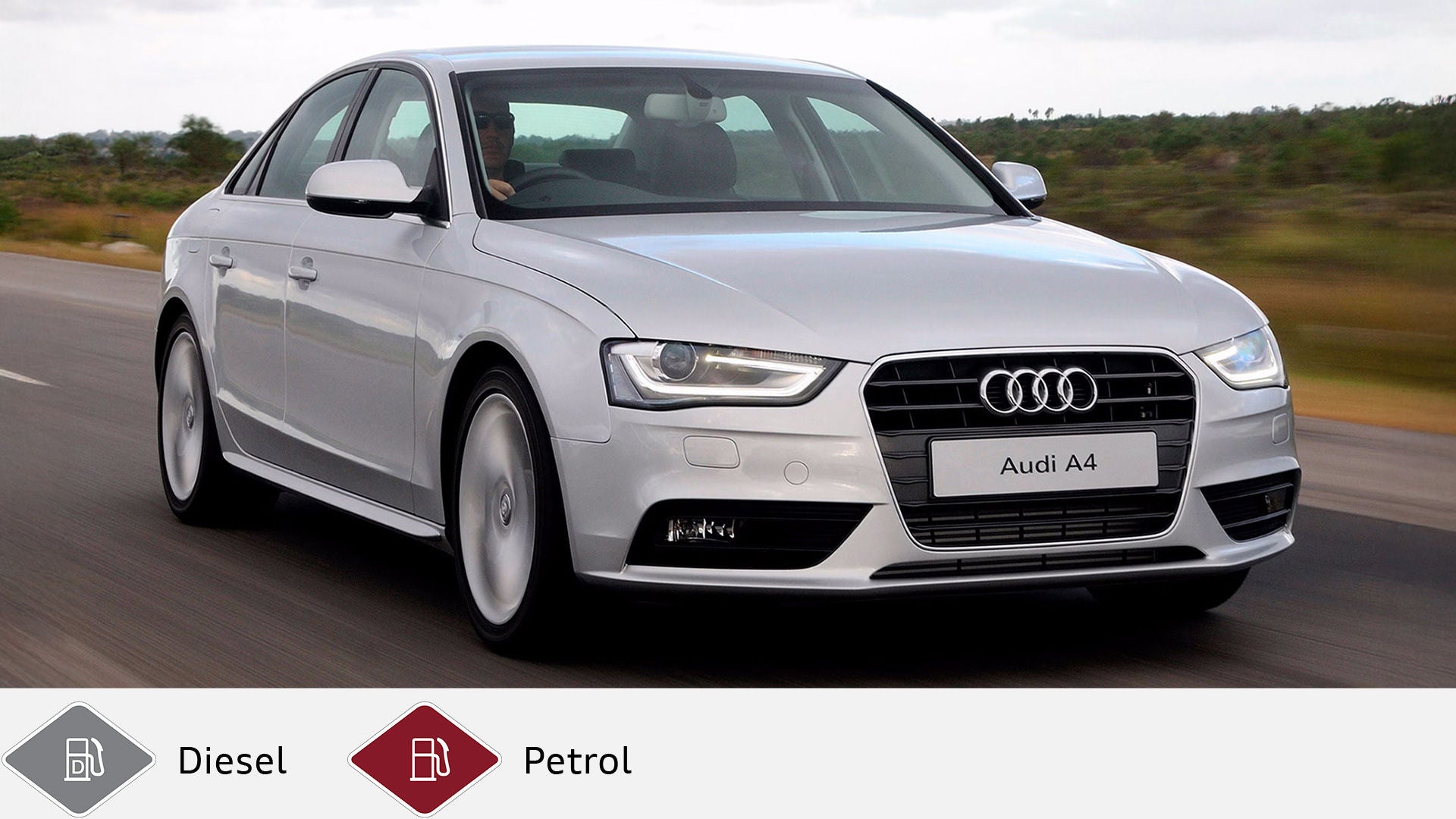 Silver Audi A4 sedan driving on a country road, driver visible behind the wheel. Gray diesel symbol and red petrol symbol at the bottom.