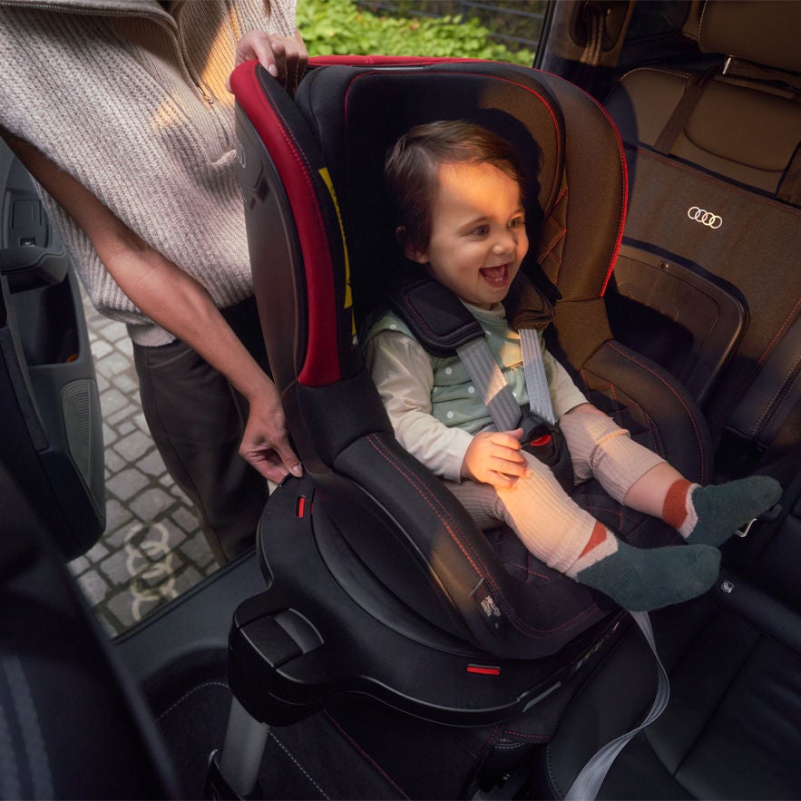Audi genuine accessories, showcasing a child strap onto a child seat