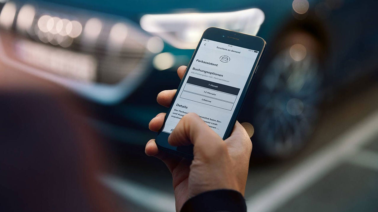 Smartphone with open myAudi app and Functions on Demand