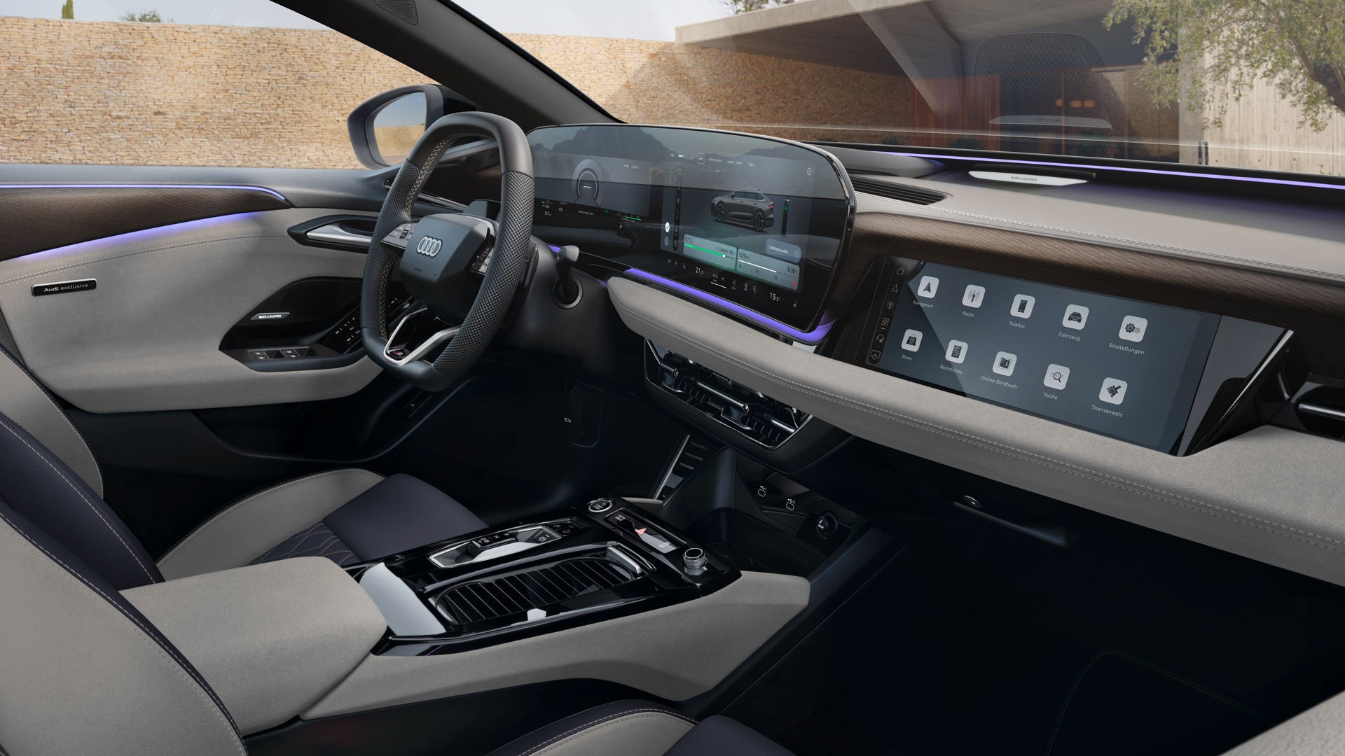 Blick ins Cockpit des A6 Sportback e-tron durch das Beifahrerfenster. Die Sitze haben Nappa Leder Bezüge in jet grau/schwarz. Die Nähte haben Kontraste in Mandelbeige.