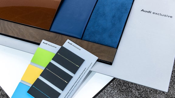 Selection of color and fabric samples with Audi exclusive brochures.