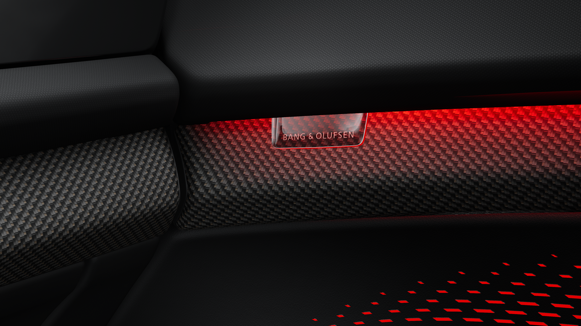 Close-up of the Bang & Olufsen logo, illuminated by a reddish interactive light.