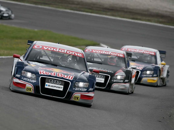 A picture of three Audi A4 DTM cars on track at Zandvoort in 2007.