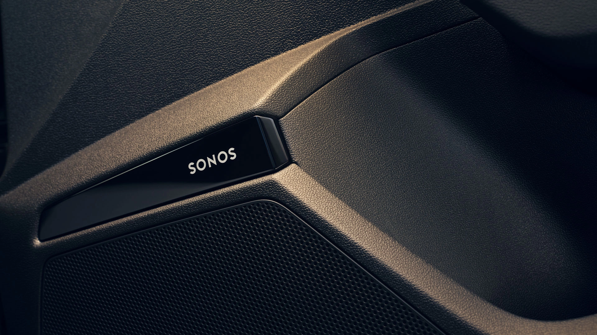 Black car interior with Sonos logo on speaker grille.