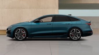 Metallic blue A6 parked against beige wall