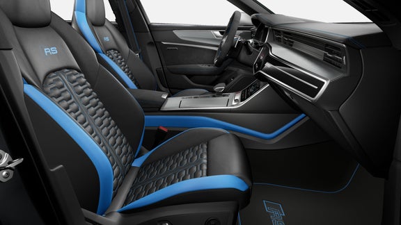 Car interior with blue and black sport seats, steering wheel, and dashboard.
