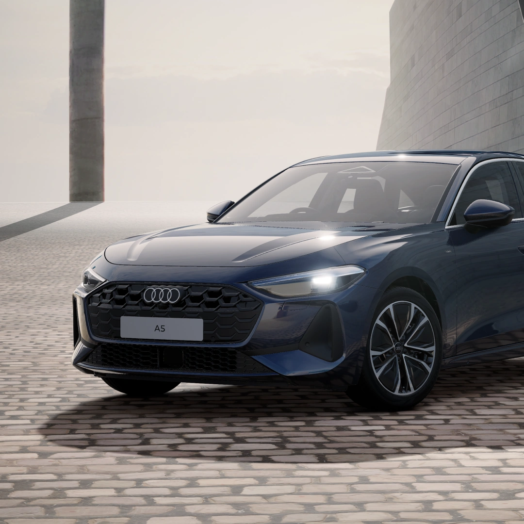 Front three-quarter view of a dark grey Audi A5 Saloon e-hybrid.