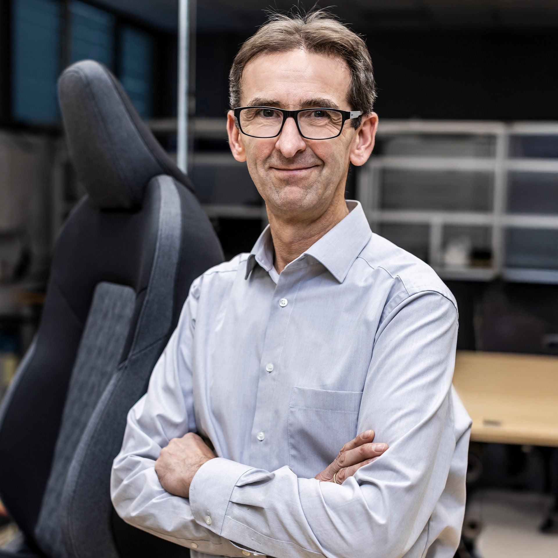 Jürgen Frank in portrait in front of a car seat
