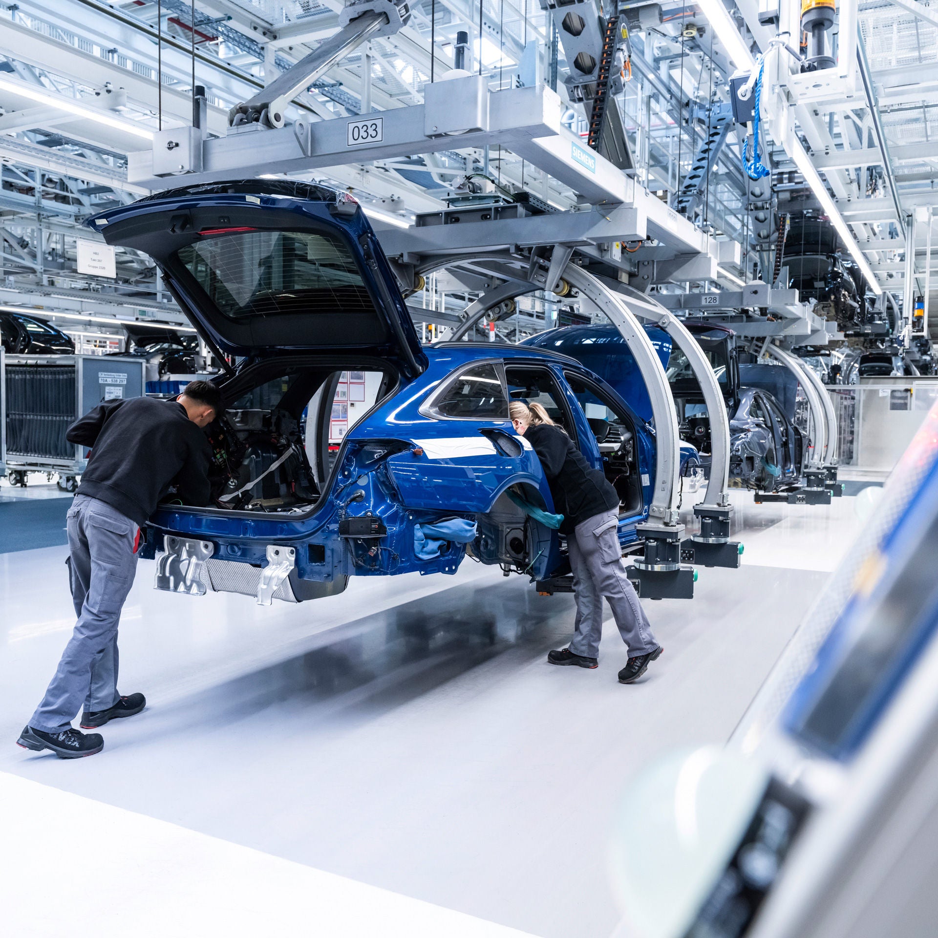 Two employees installing parts in production.
