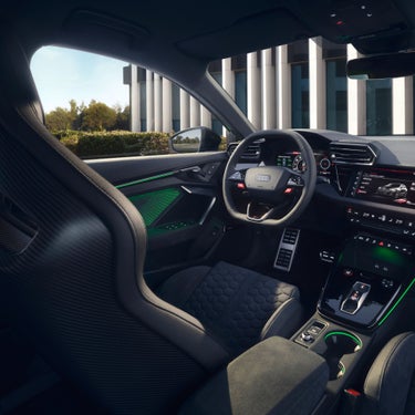  Interior view of an Audi RS3 Sportback car highlighting the steering wheel and dashboard.