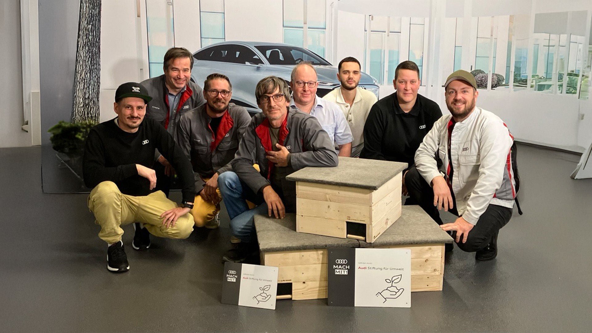 Group poses with hedgehog houses