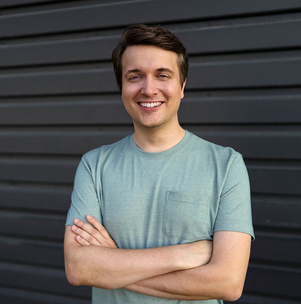 Jan Totz laughs at the camera with his arms crossed