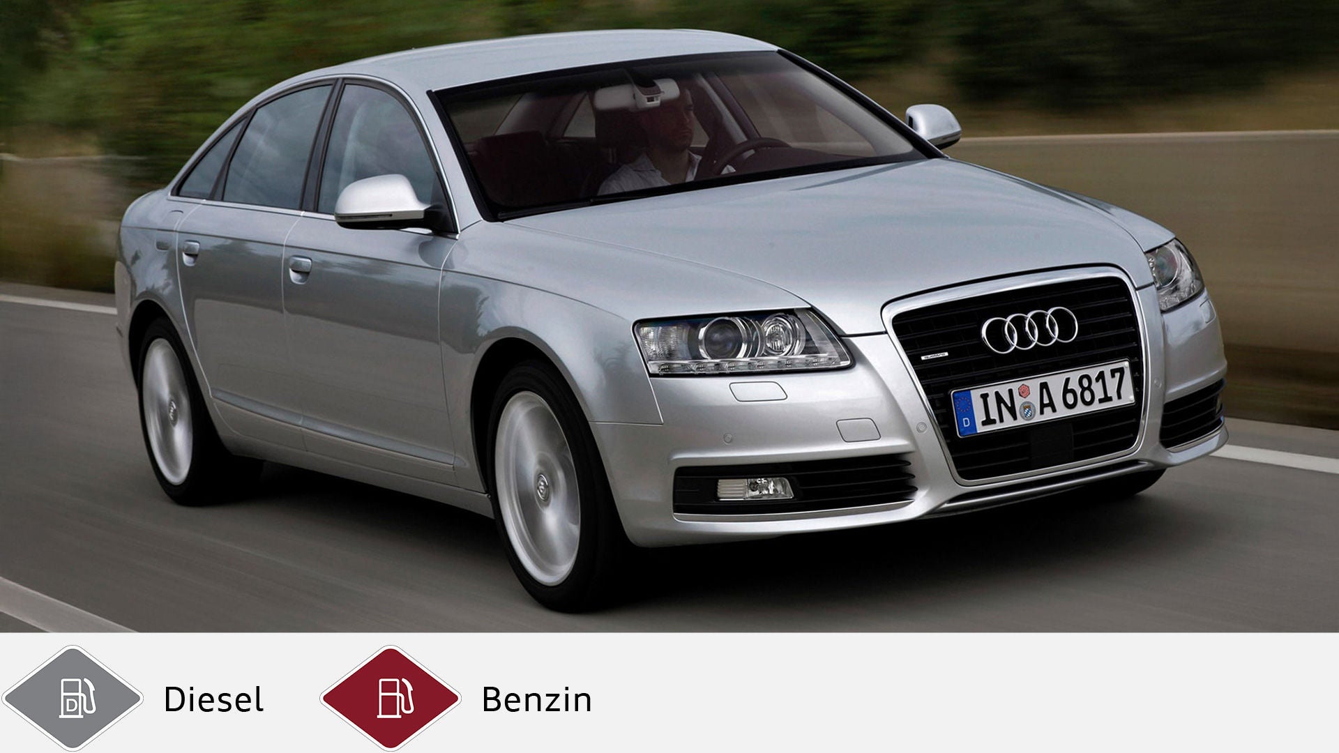 Silberner Audi A6 Limousine (2008–2011) in Fahrt auf Landstraße, Frontansicht mit Fahrer sichtbar. Unten graues Dieselsymbol und rotes Benzinsymbol.