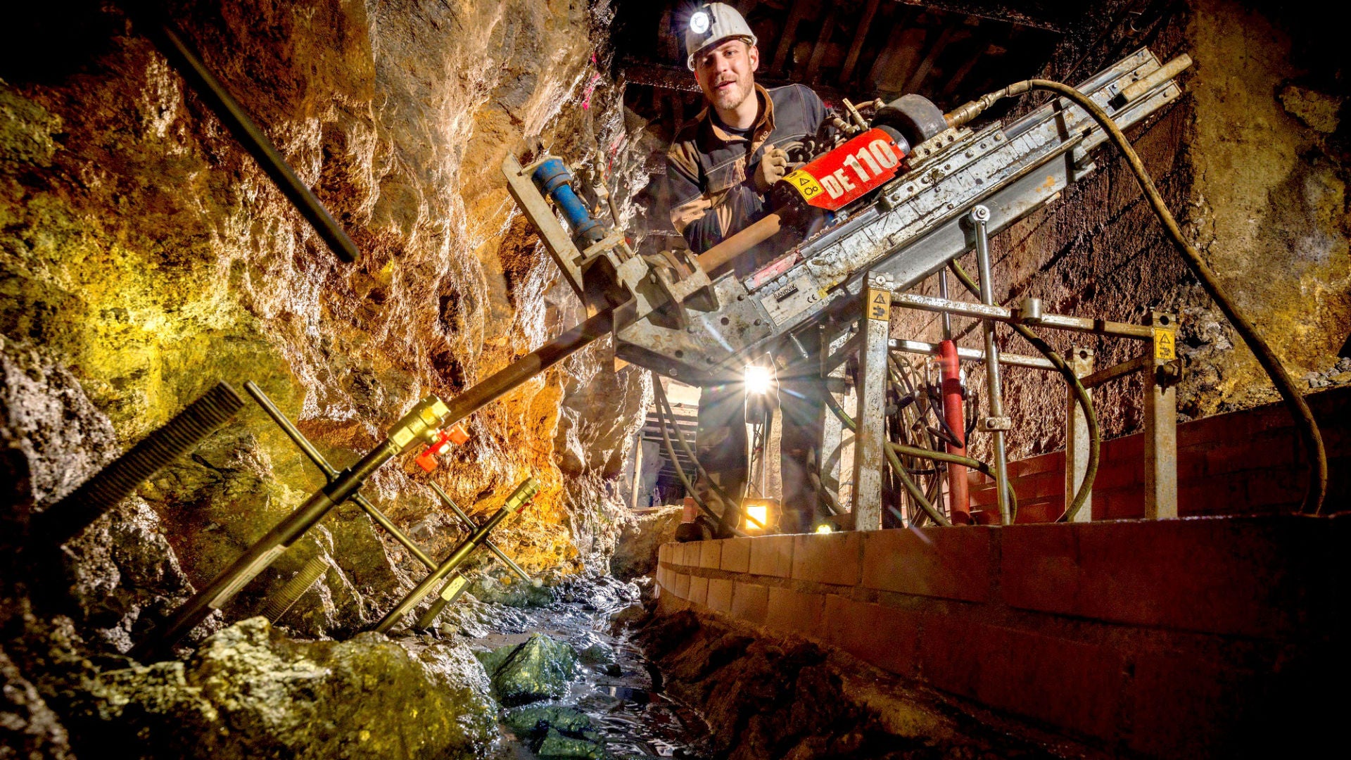 Mann im Untergrund an einem großen Bohrer