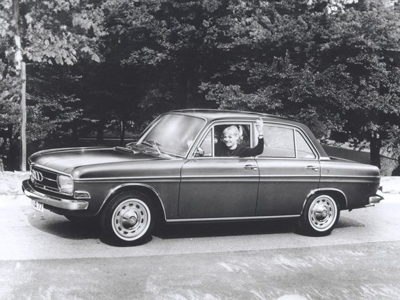 Black and white shot of a woman sitting in a Union Audi car and holding her arm out of the window