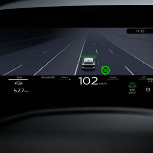 Nahaufnahme eines Displays im Fahrzeuginnenraum. Abgebildet ist die Silhouette eine Fahrzeugs in Geradeausfahrt. Darunter angeordnet sind unter anderem die aktuelle Geschwindigkeit und die Restreichweite.