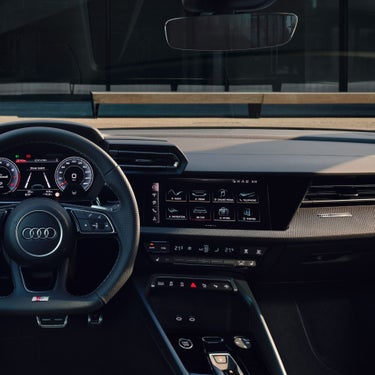 Interior view of an Audi car focusing on the steering wheel and dashboard.