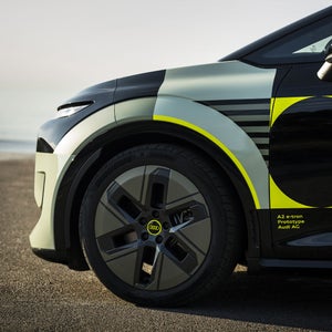 Close-up of the left front wheel of the Audi A2 e-tron with yellowish wrap.