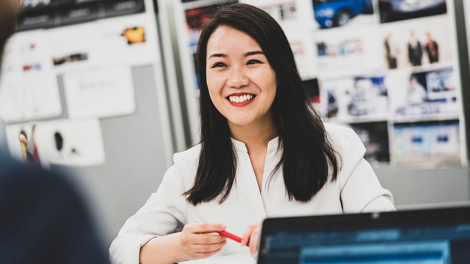 A woman laughs past the camera