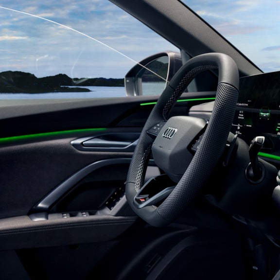 Car interior with sleek dashboard, digital displays, and ambient lighting.