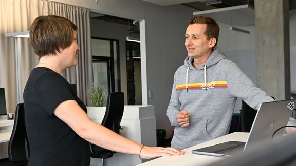 Dani, Ambassador SDC, is in conversation with a colleague