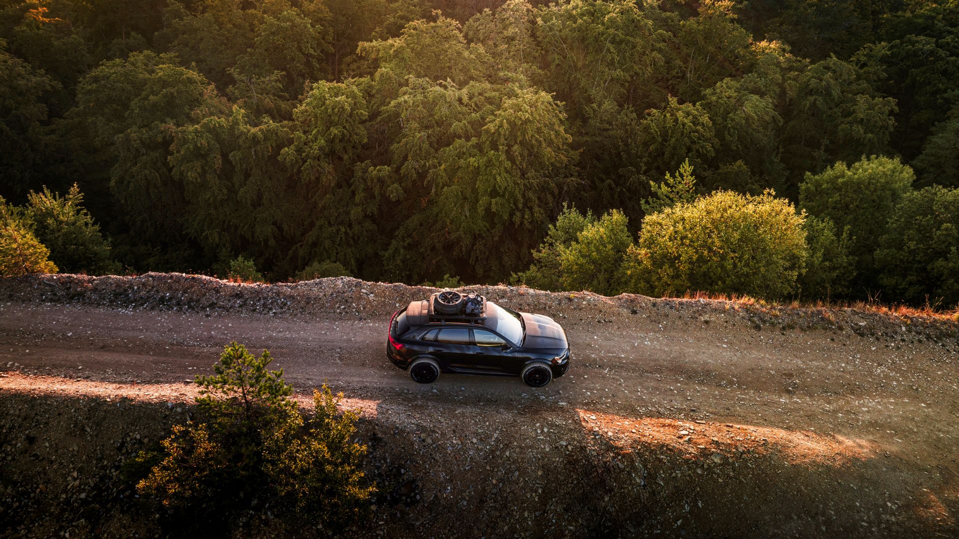 Bird's-eye view of an Audi model on a sandy road