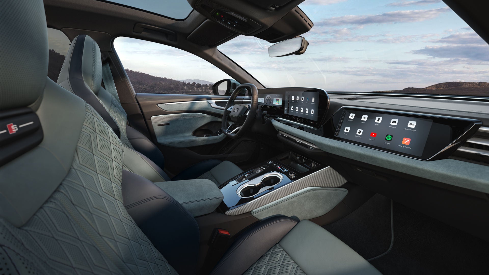 View through the passenger window into the cockpit of the A6 Avant e-hybrid. The interior has mint gray upholstery.