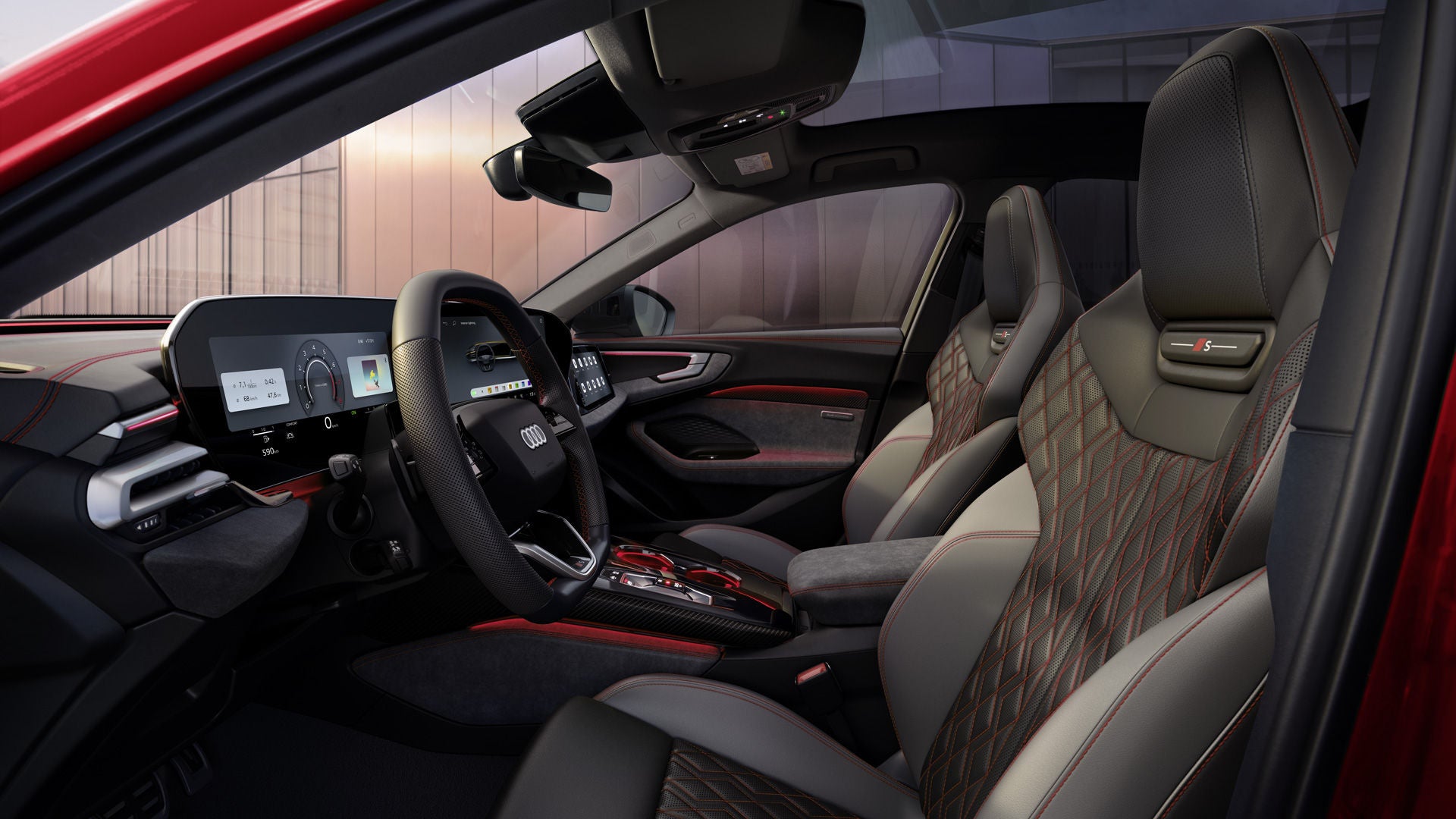 View through the driver's door into the cockpit of the A5 Saloon. The interior upholstery is black and jet gray with crimson contrasts.